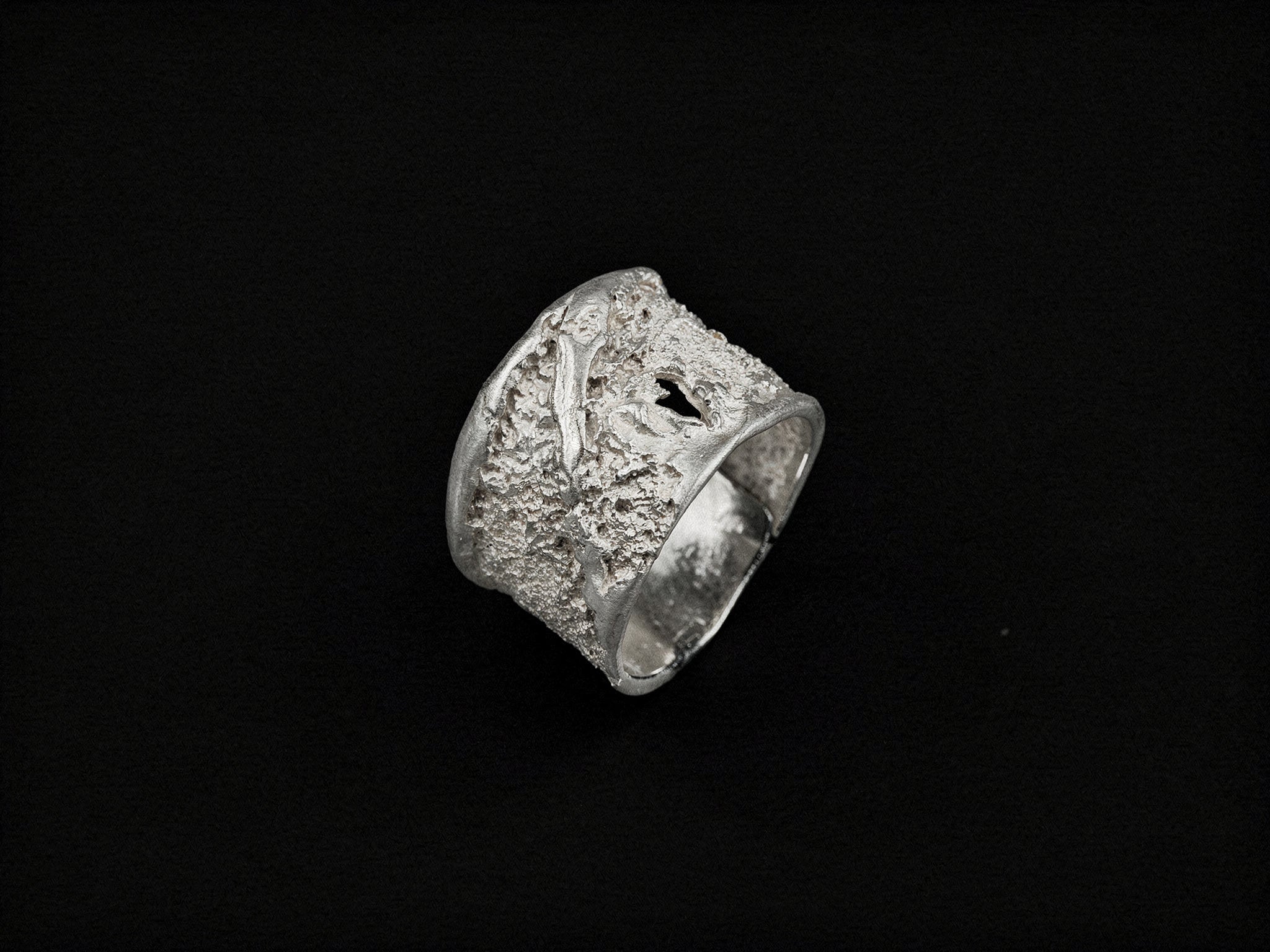 Silver strata-textured ring with dark inlay, chunky square silhouette