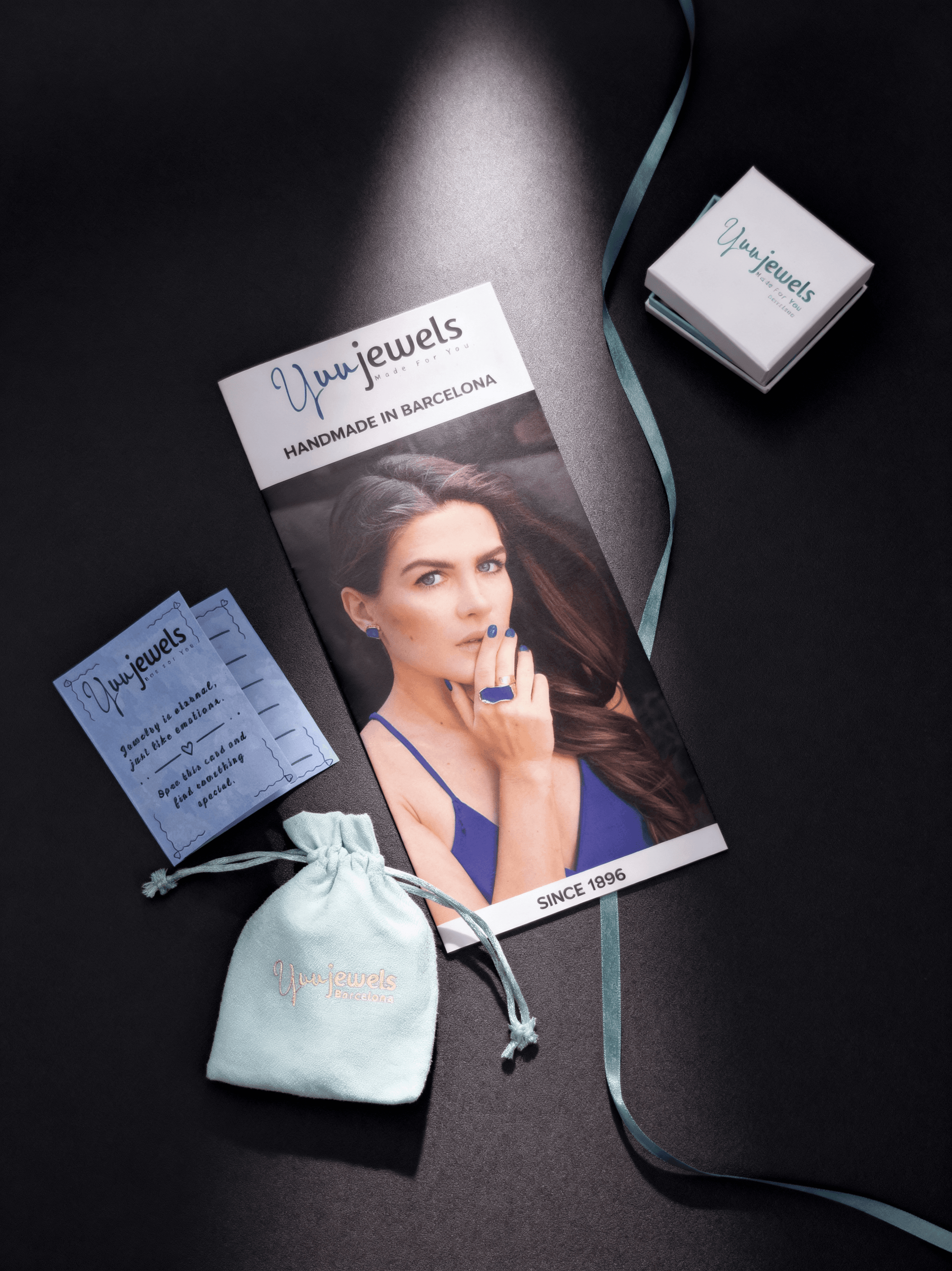 Pendant jewelry packaging with brand cards and a small drawstring pouch