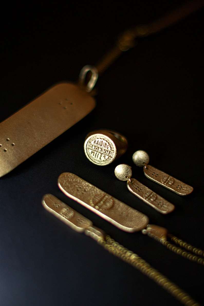 Skateboard Stud Movement Earrings handcrafted jewelry detail