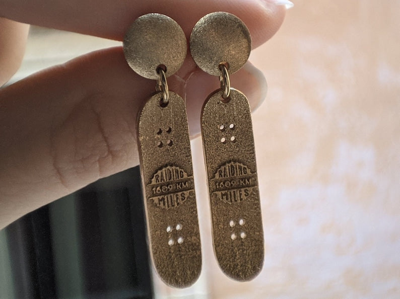 Skateboard Stud Movement Earrings in gold or silver plated bronze with minimalist design