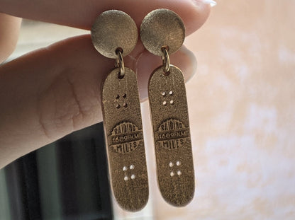 Skateboard Stud Movement Earrings in gold or silver plated bronze with minimalist design