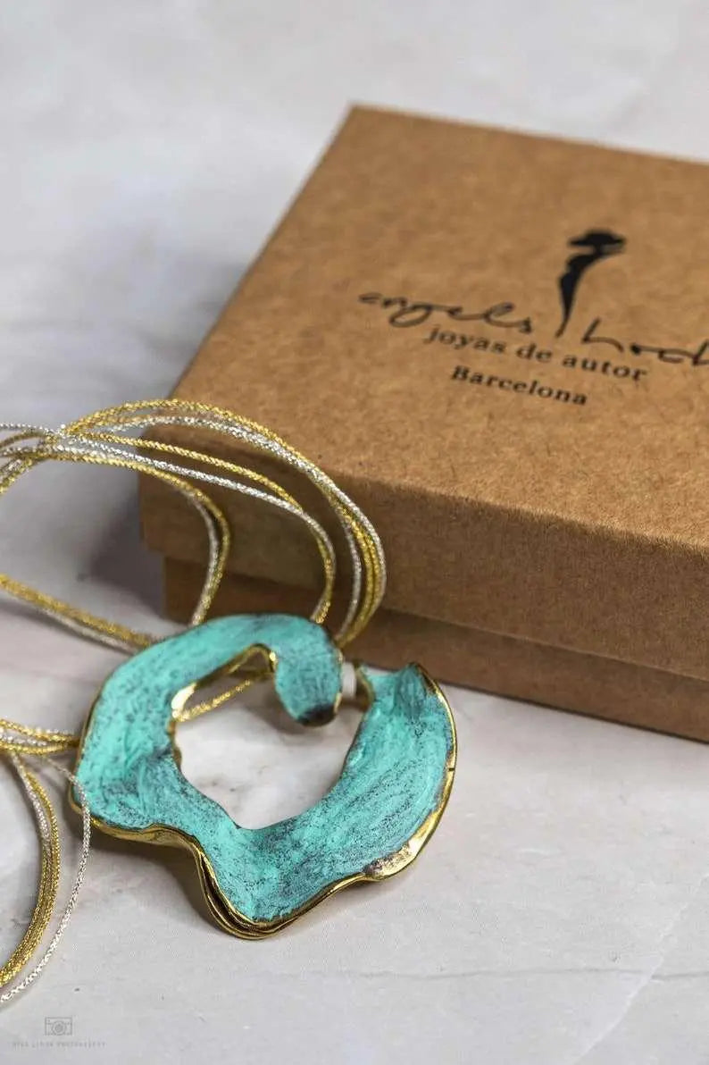 Eternal C Pendant necklace in gold-plated bronze with sculptural design
