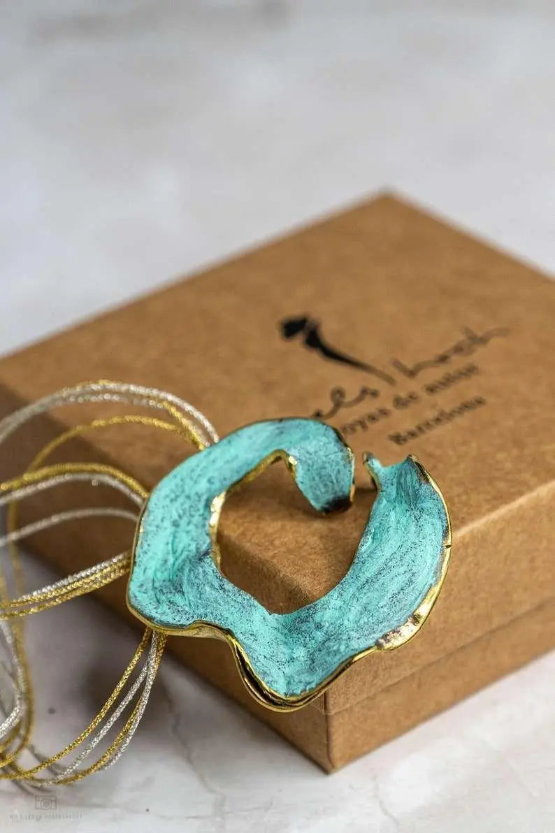 Eternal C Pendant detail showing artisanal texture