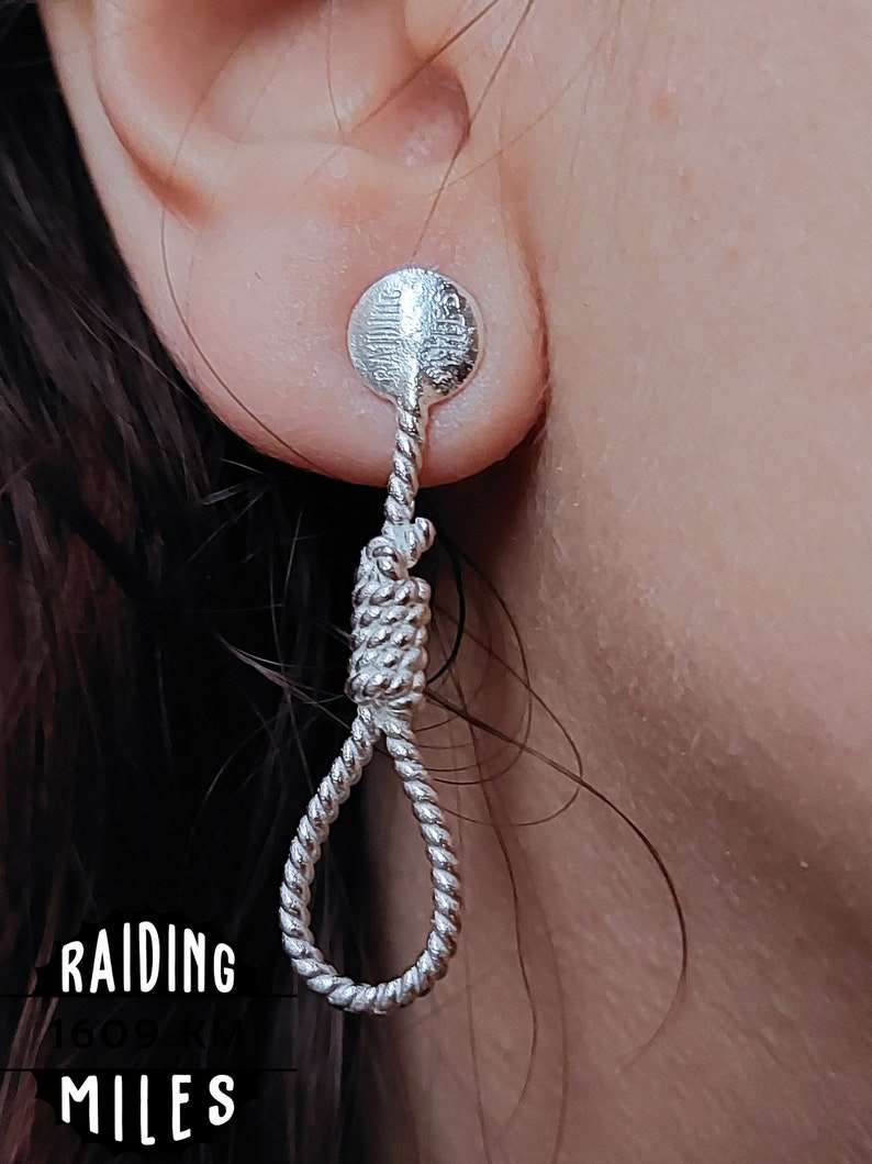 Rope-shaped silver dangle earring with textured round top and twisted coil rope loop