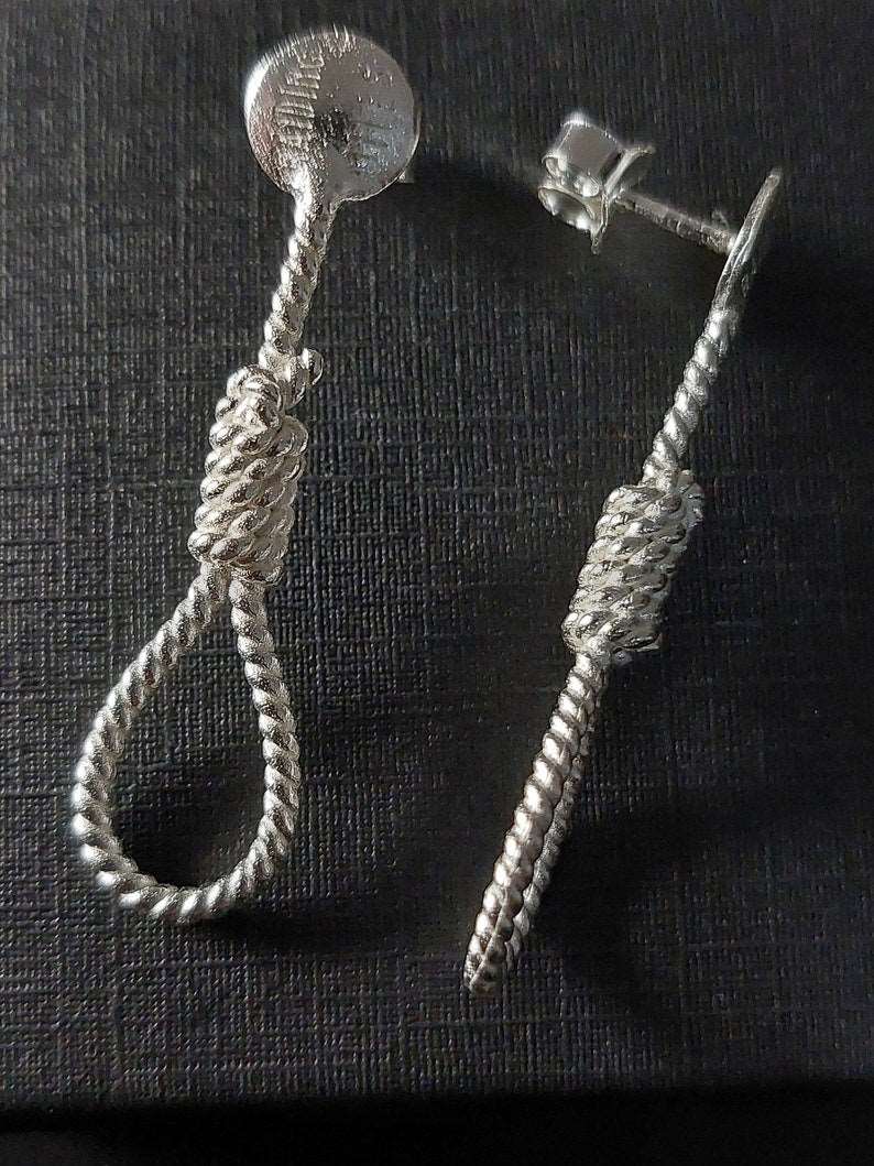 Silver rope-shaped stud earrings with round tops and twisted rope teardrop drops