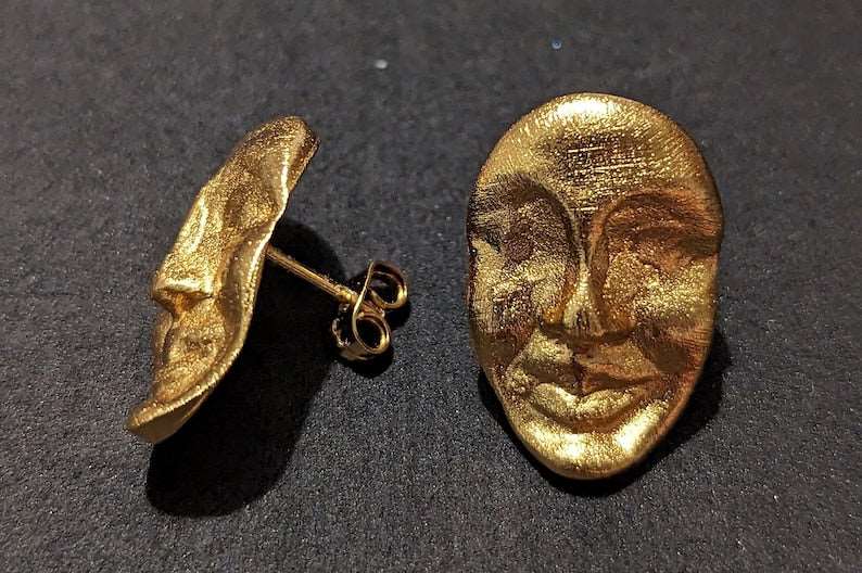 Gold face stud earrings pair