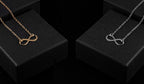Infinity pendant necklace set, silver and gold on black display boxes