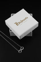 Silver infinity pendant necklace with fine chain on white gift box