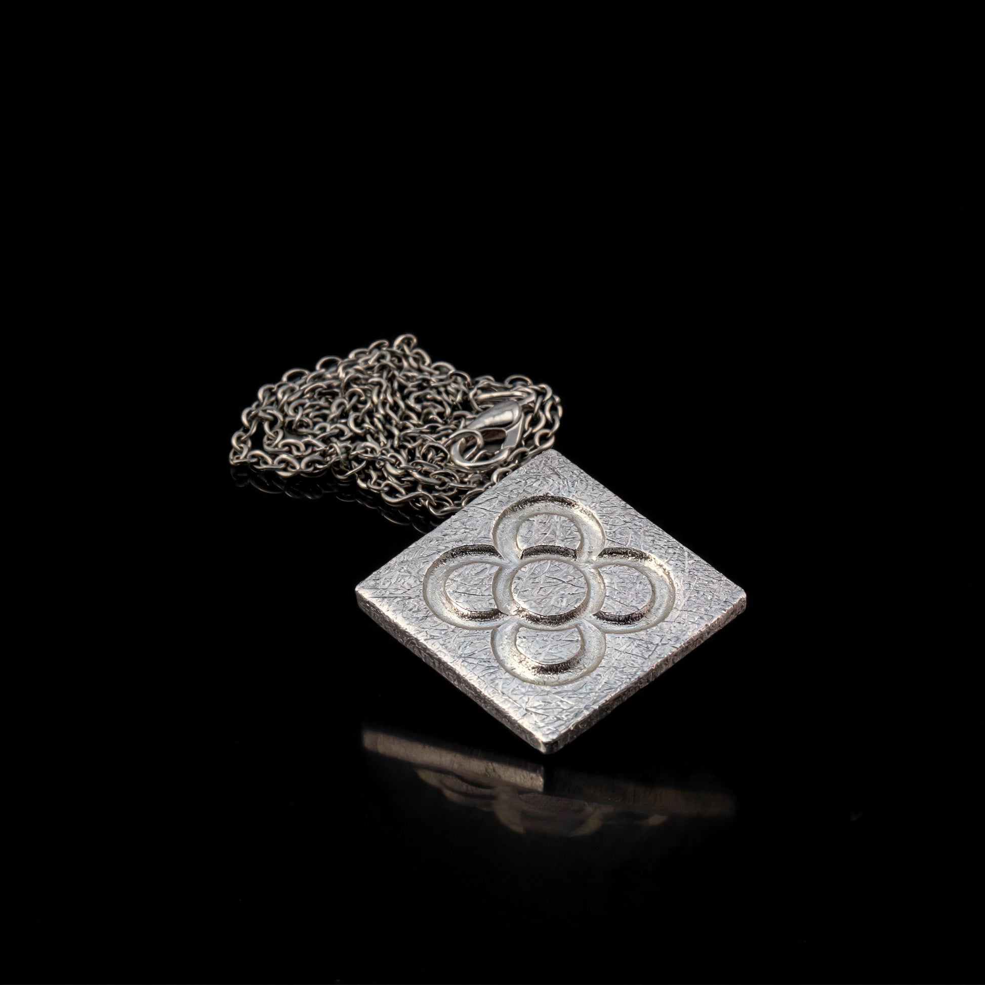 Silver square flower pendant with curly chain