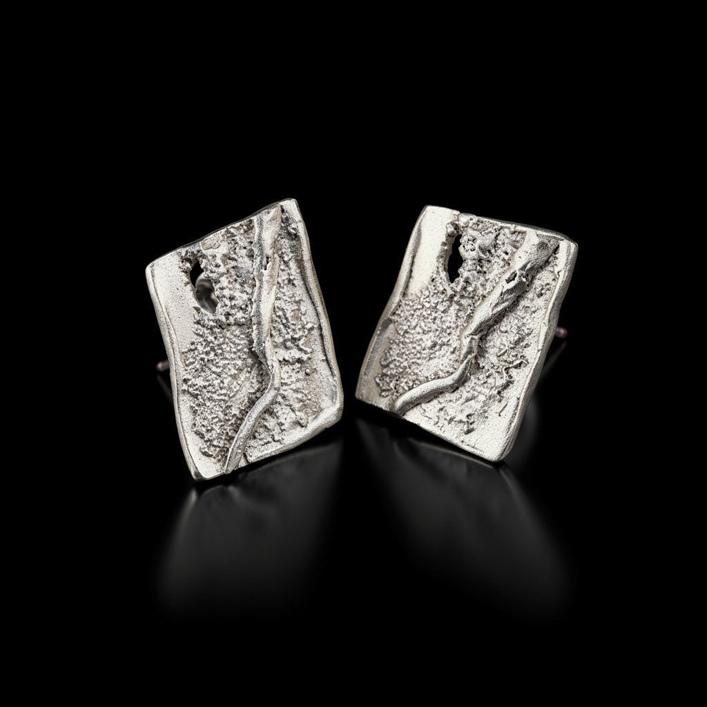 Silver square stud earrings with textured, layered pattern