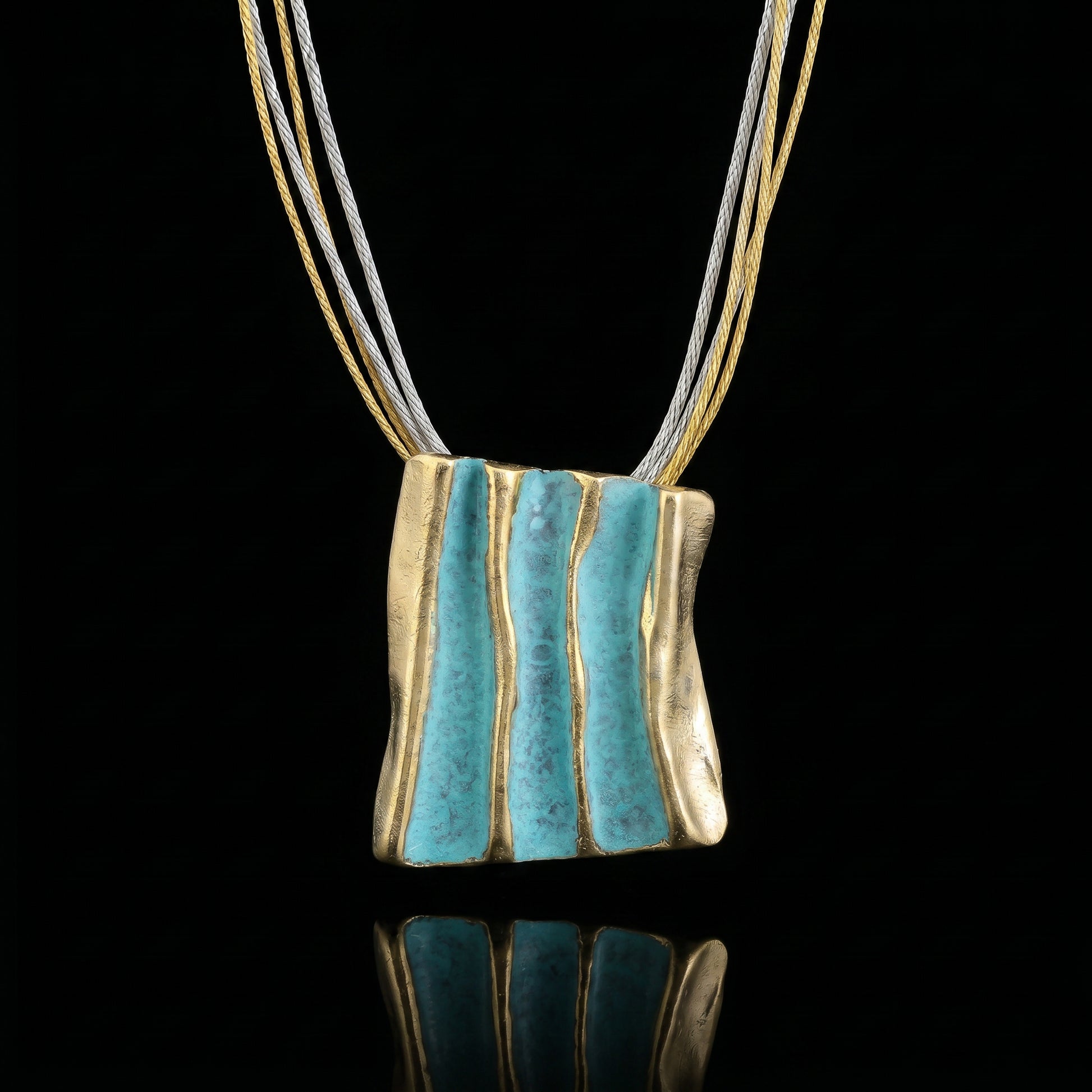 Gold and turquoise striped pendant necklace on braided cord strands