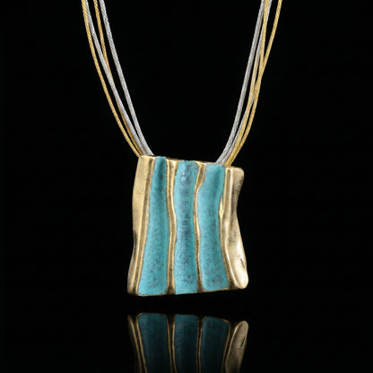 Gold and turquoise striped pendant necklace on braided cord strands