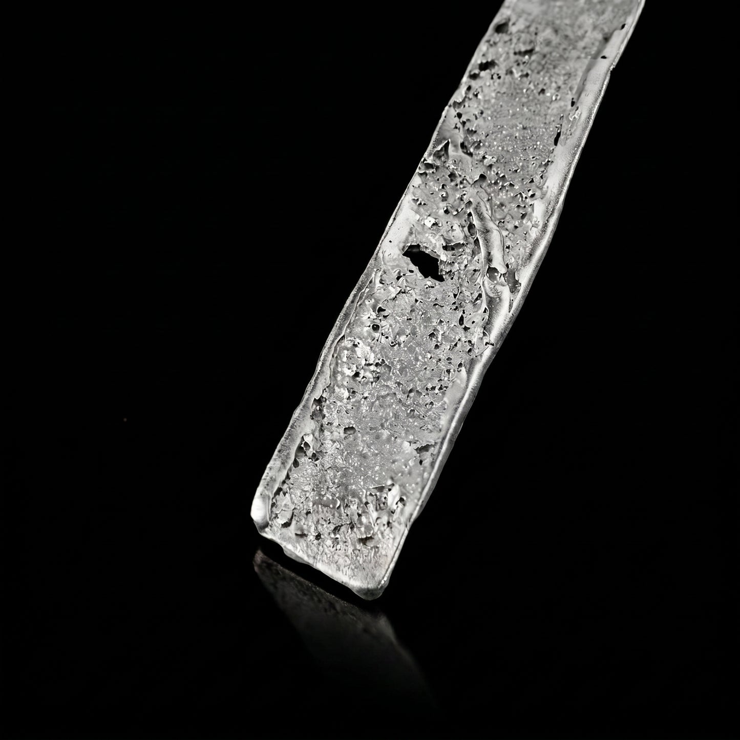 Silver strata necklace pendant close-up with textured silver slab