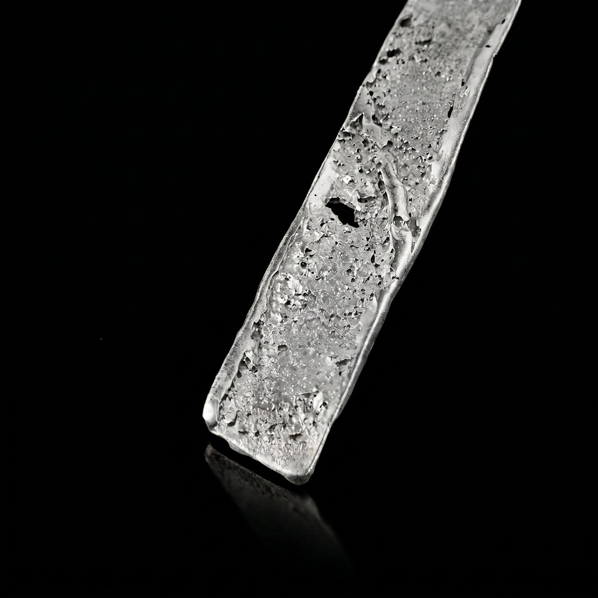 Silver strata necklace pendant close-up with textured silver slab