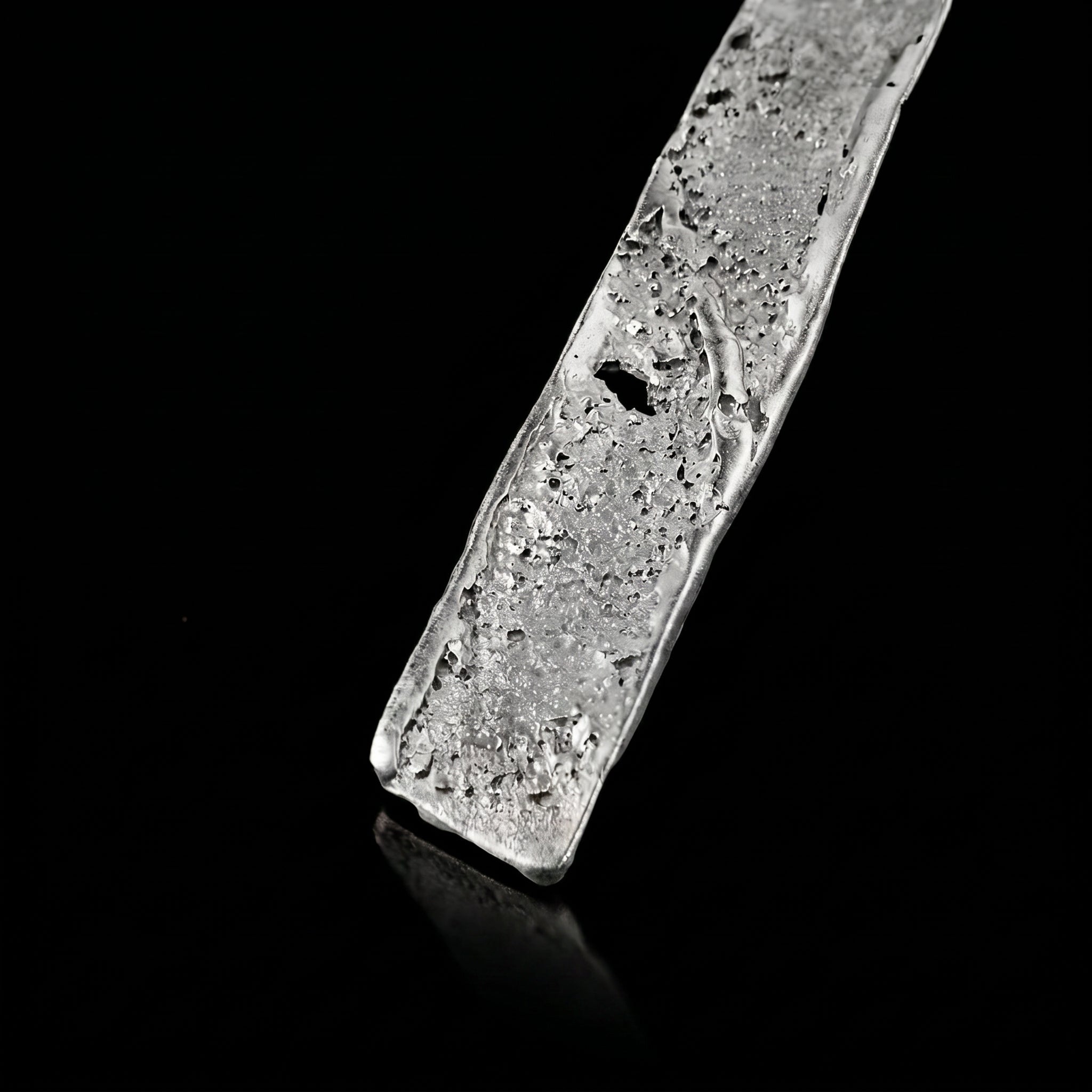 Silver strata necklace pendant close-up with textured silver slab