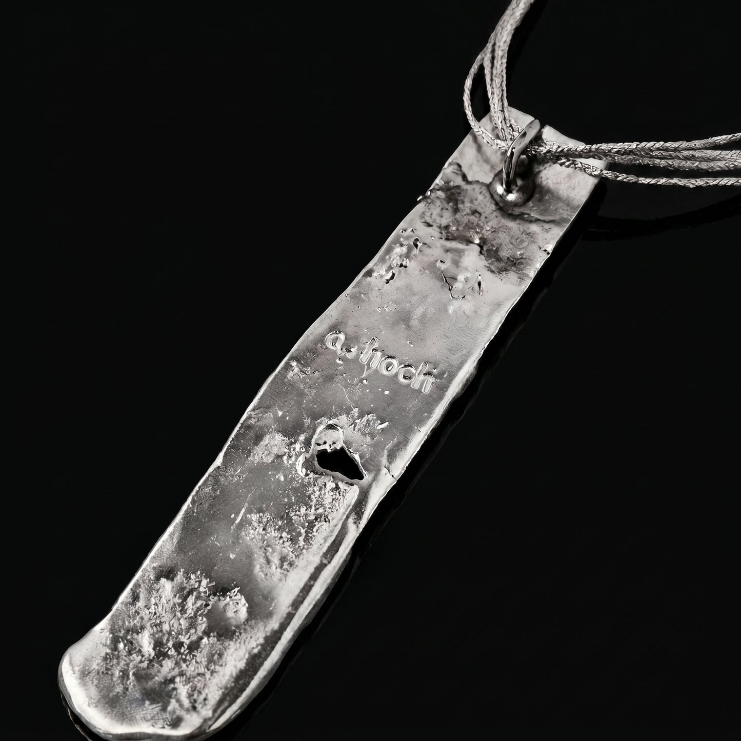 Silver strata necklace pendant with engraved script on textured silver slab