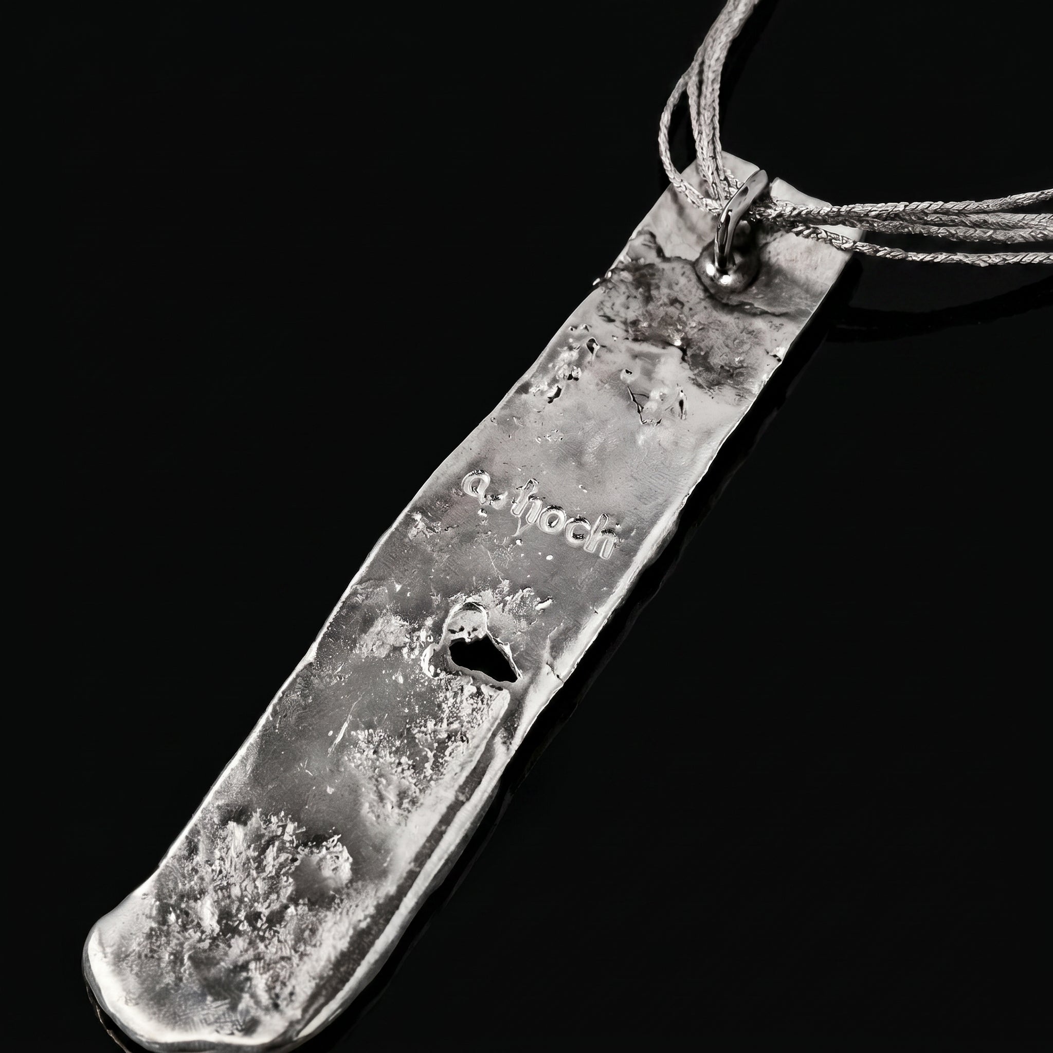 Silver strata necklace pendant with engraved script on textured silver slab