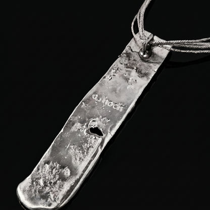 Silver strata necklace pendant with engraved script on textured silver slab