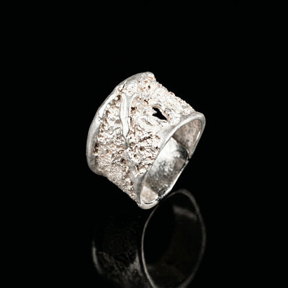 Silver strata ring with textured square top and open band, reflective finish