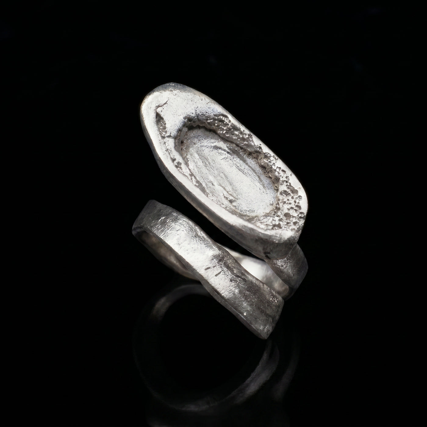 Silver-tone oval signet ring with textured, engraved top