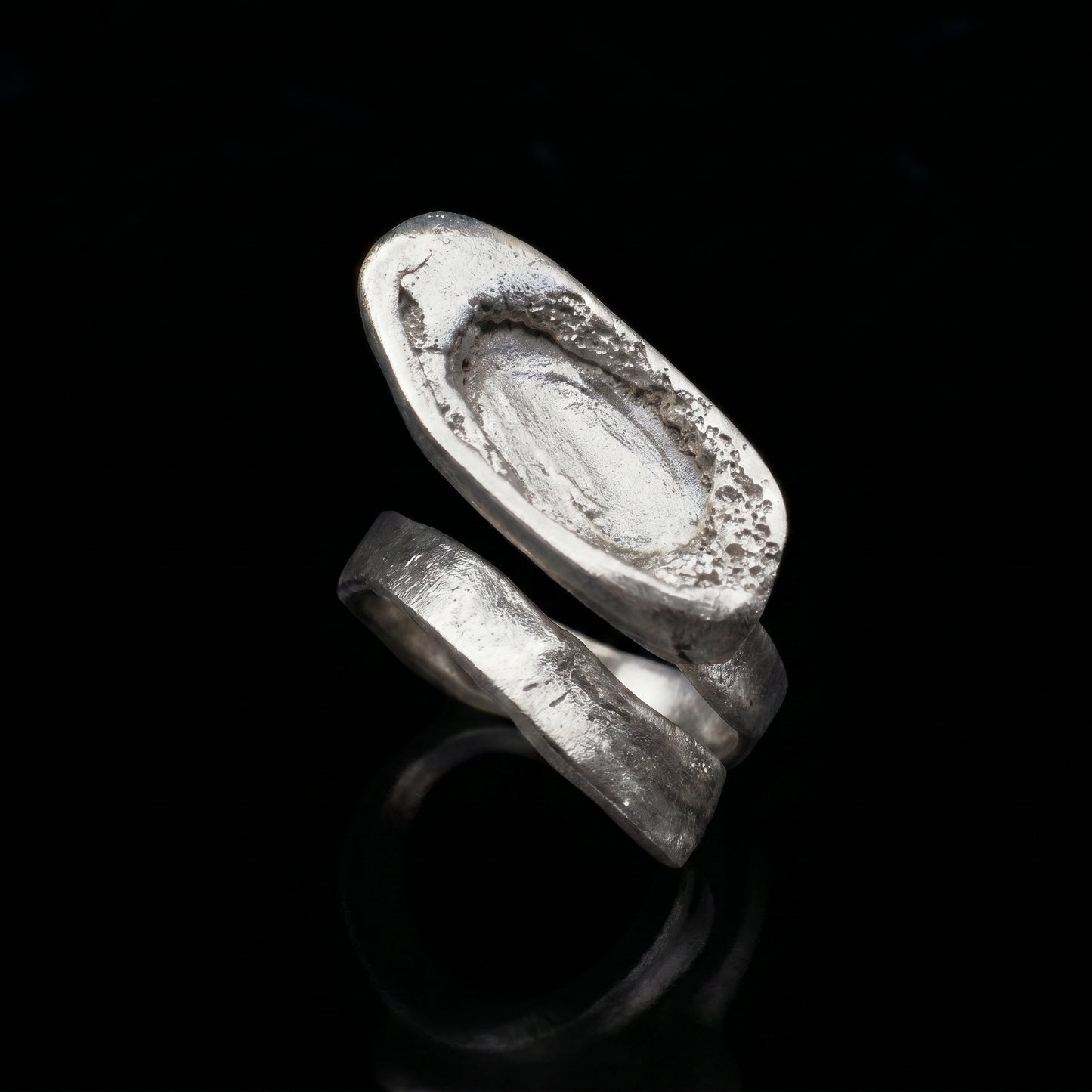 Silver-tone oval signet ring with textured, engraved top
