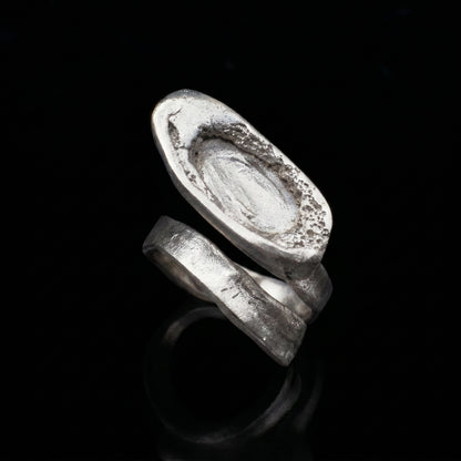 Silver-tone oval signet ring with textured, engraved top