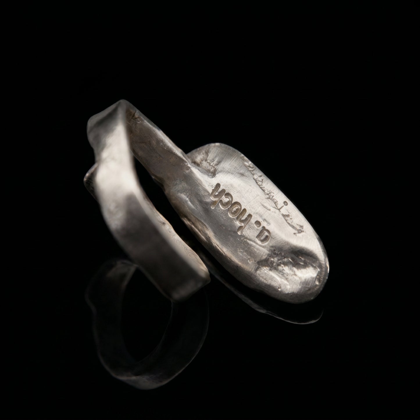 Silver-tone oval ring with stamped design on inner band