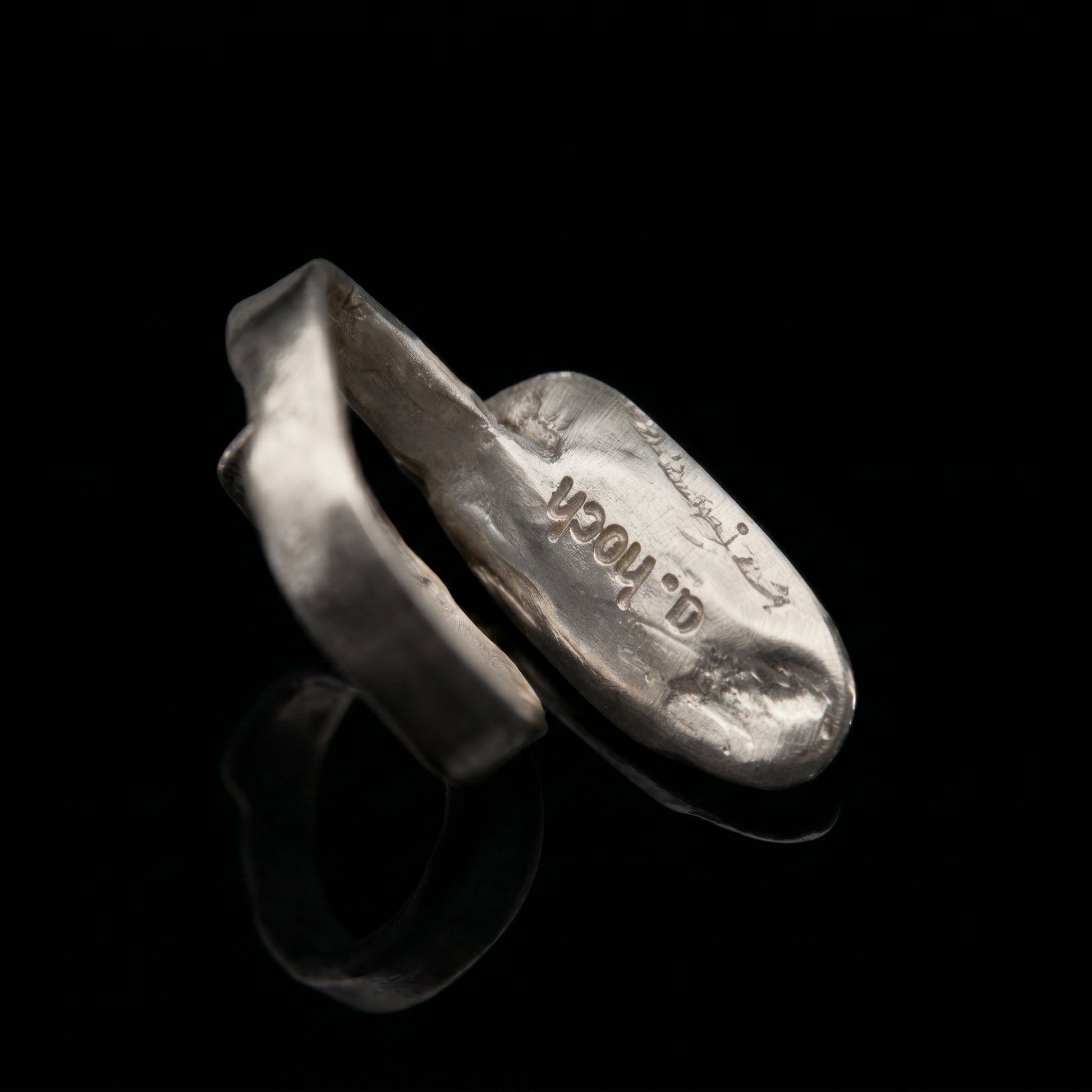 Silver-tone oval ring with stamped design on inner band