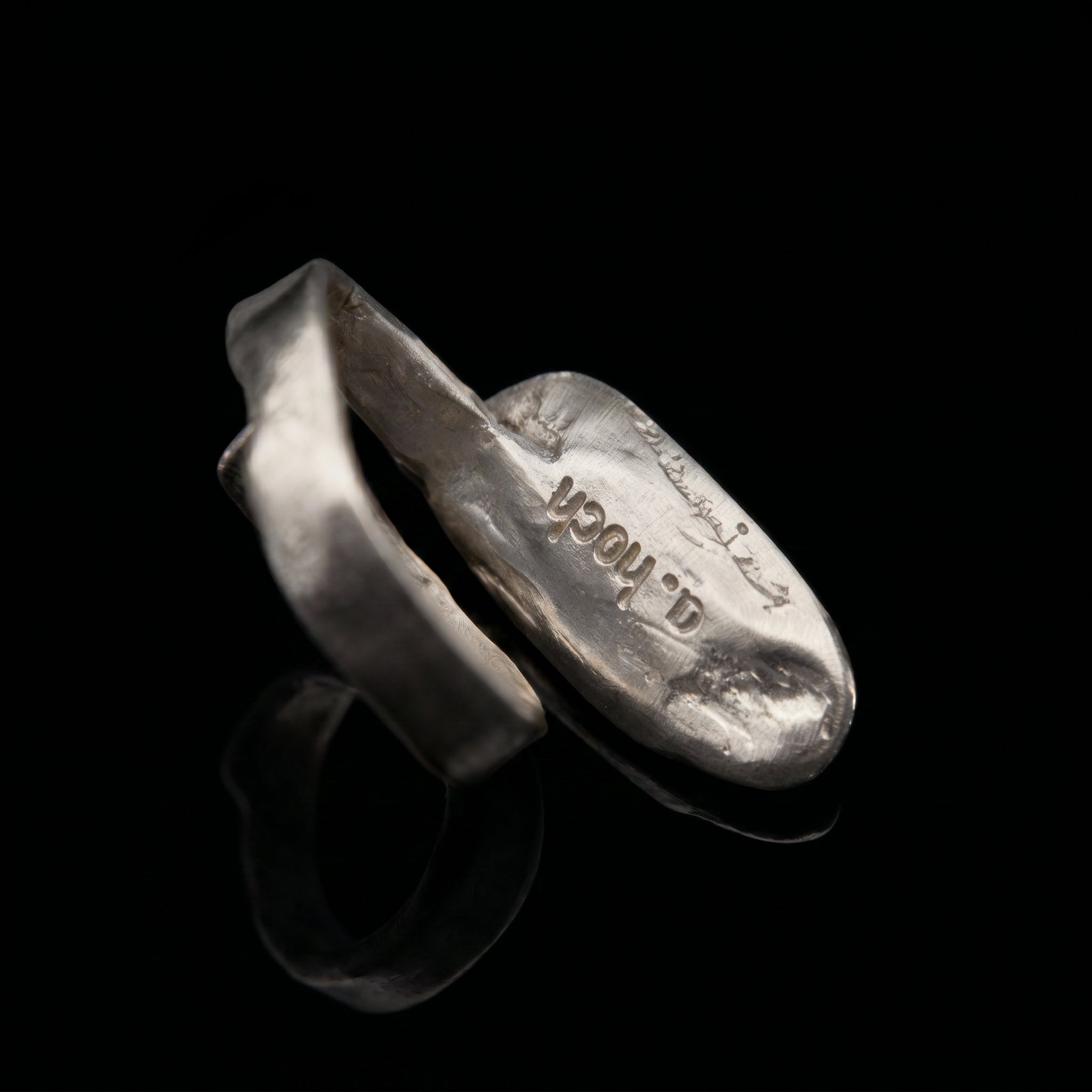 Silver-tone oval ring with stamped design on inner band