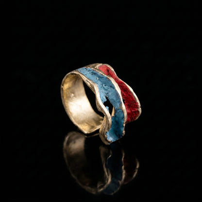 Gold-tone ring with blue and red resin inlay, curved open band