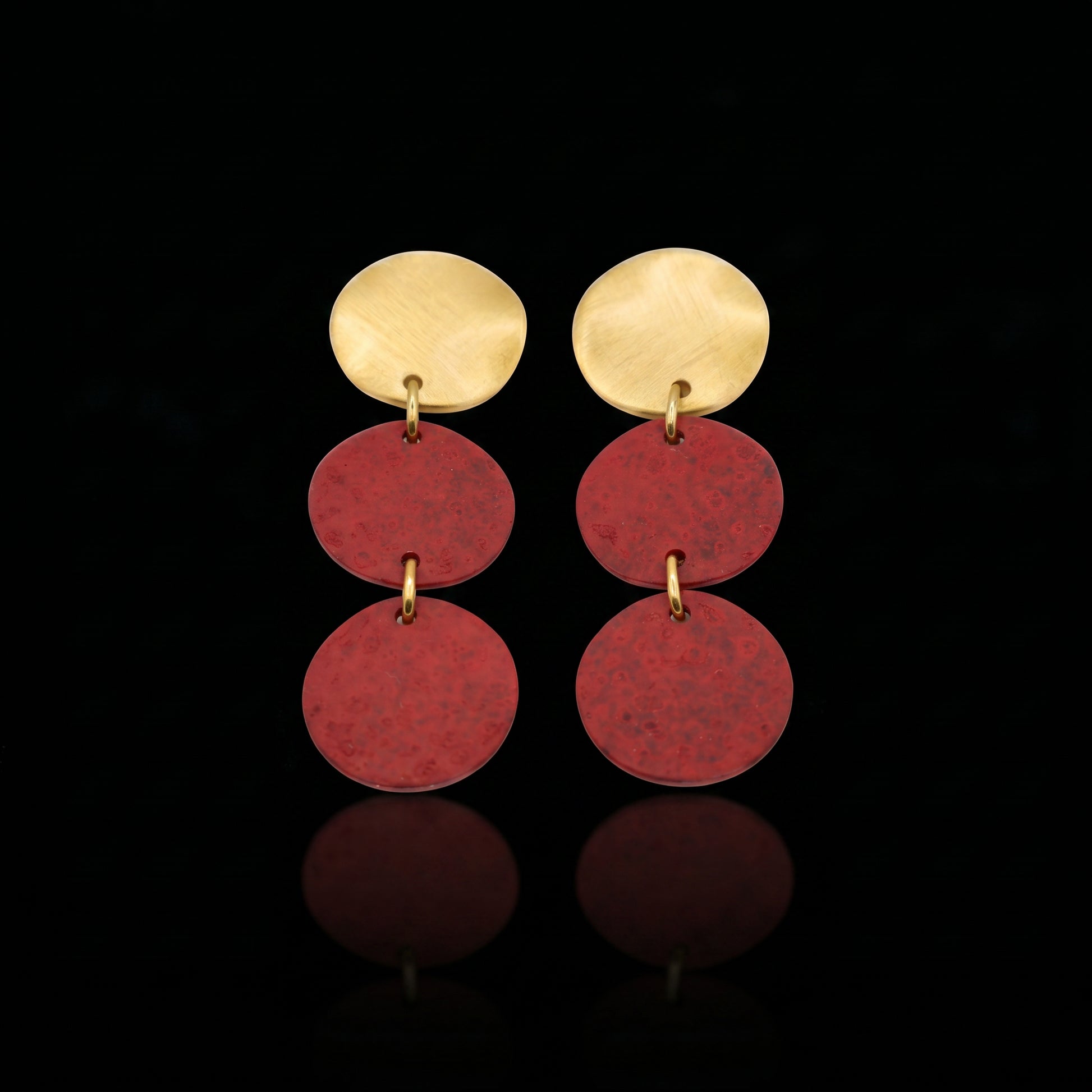 Three-disc motion earrings with gold-tone top and stacked red round dangles