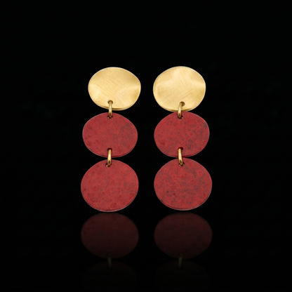 Three-disc motion earrings with gold-tone top and stacked red round dangles