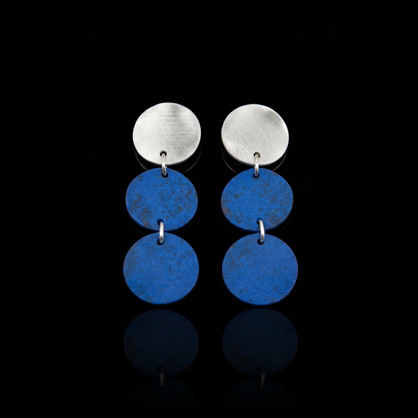 Three-disc motion earrings with silver-tone top and two stacked blue round dangles