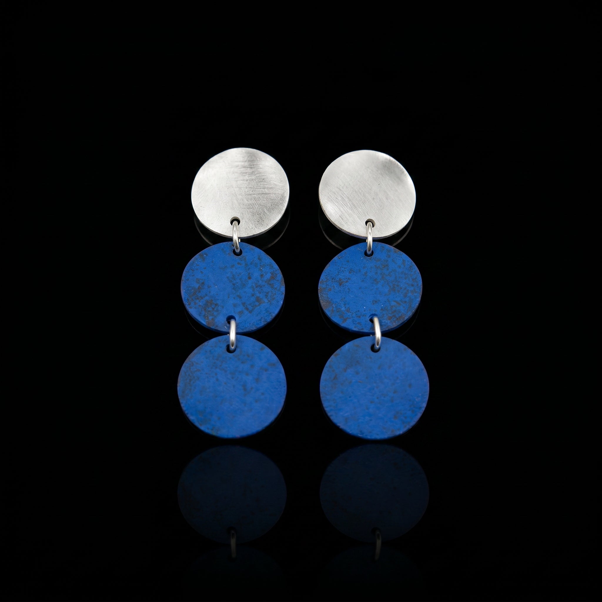 Three-disc motion earrings with silver-tone top and two stacked blue round dangles