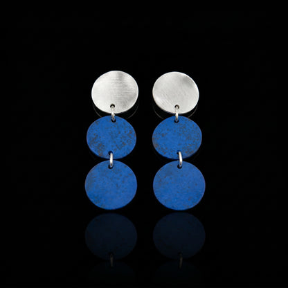 Three-disc motion earrings with silver-tone top and two stacked blue round dangles