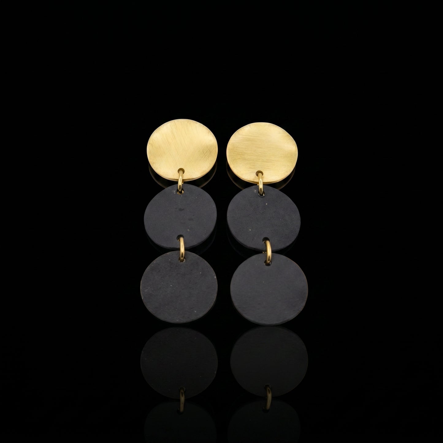 Three-disc motion earrings with gold-tone tops and two stacked dark gray discs
