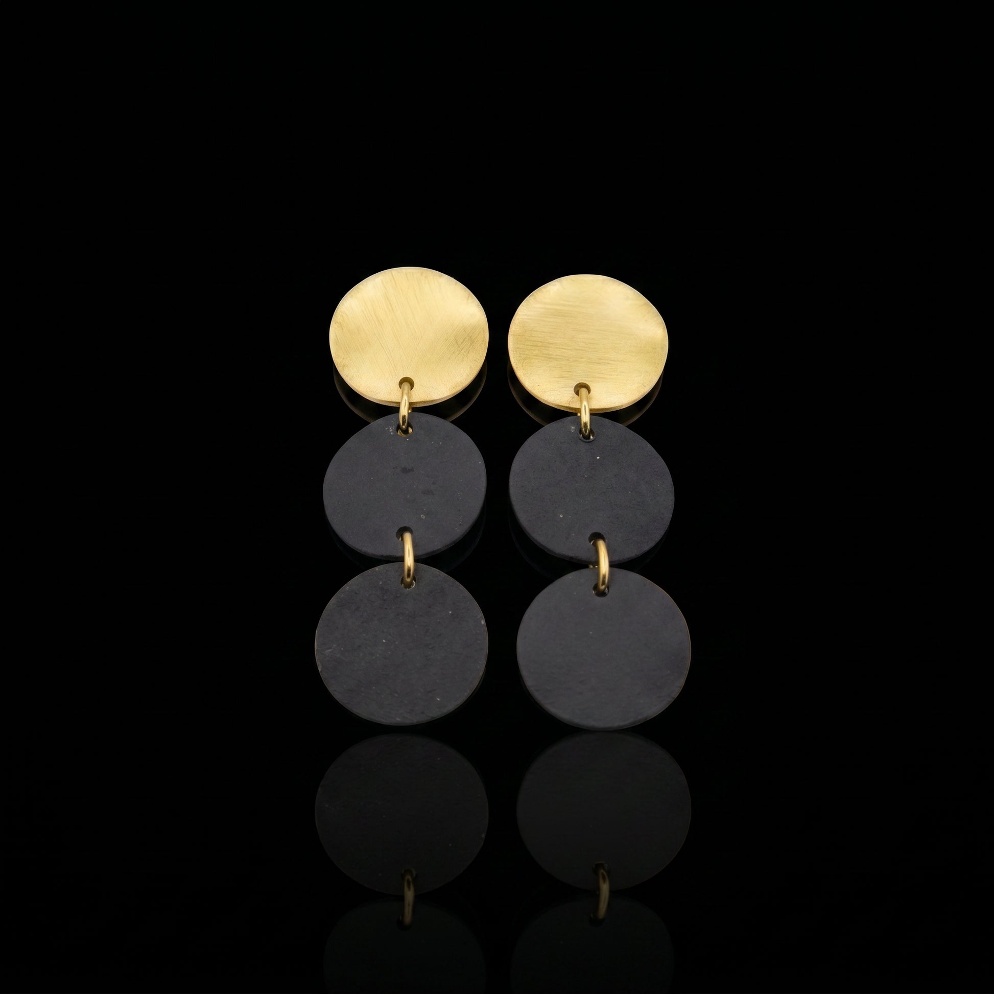 Three-disc motion earrings with gold-tone tops and two stacked dark gray discs