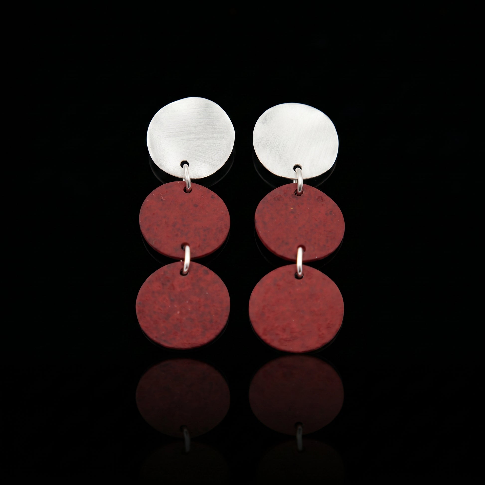 Silver-tone triple motion drop earrings with three maroon discs