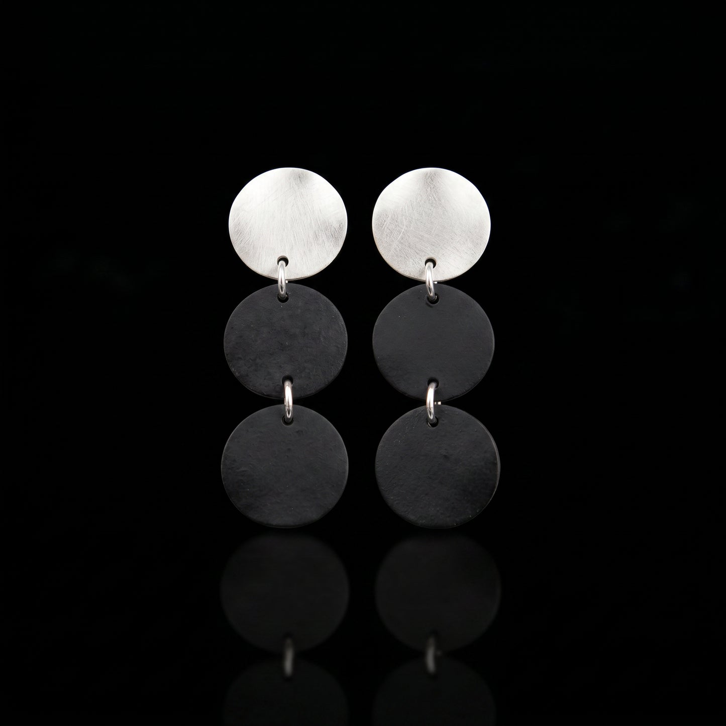 Three-disc motion earrings with silver-tone top and two stacked dark gray disc drops