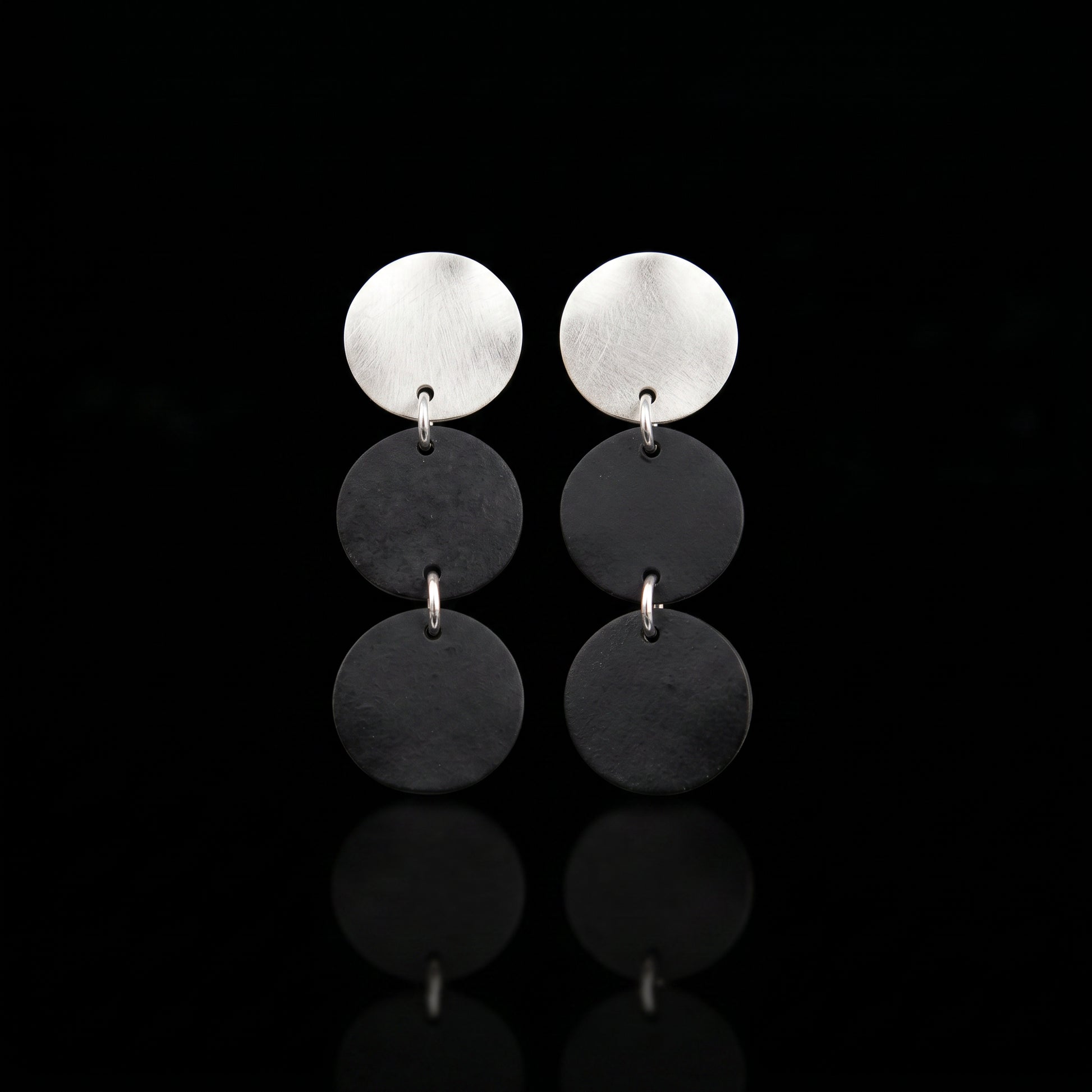 Three-disc motion earrings with silver-tone top and two stacked dark gray disc drops