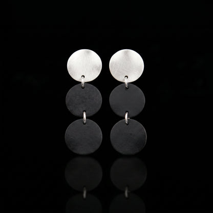 Three-disc motion earrings with silver-tone top and two stacked dark gray disc drops