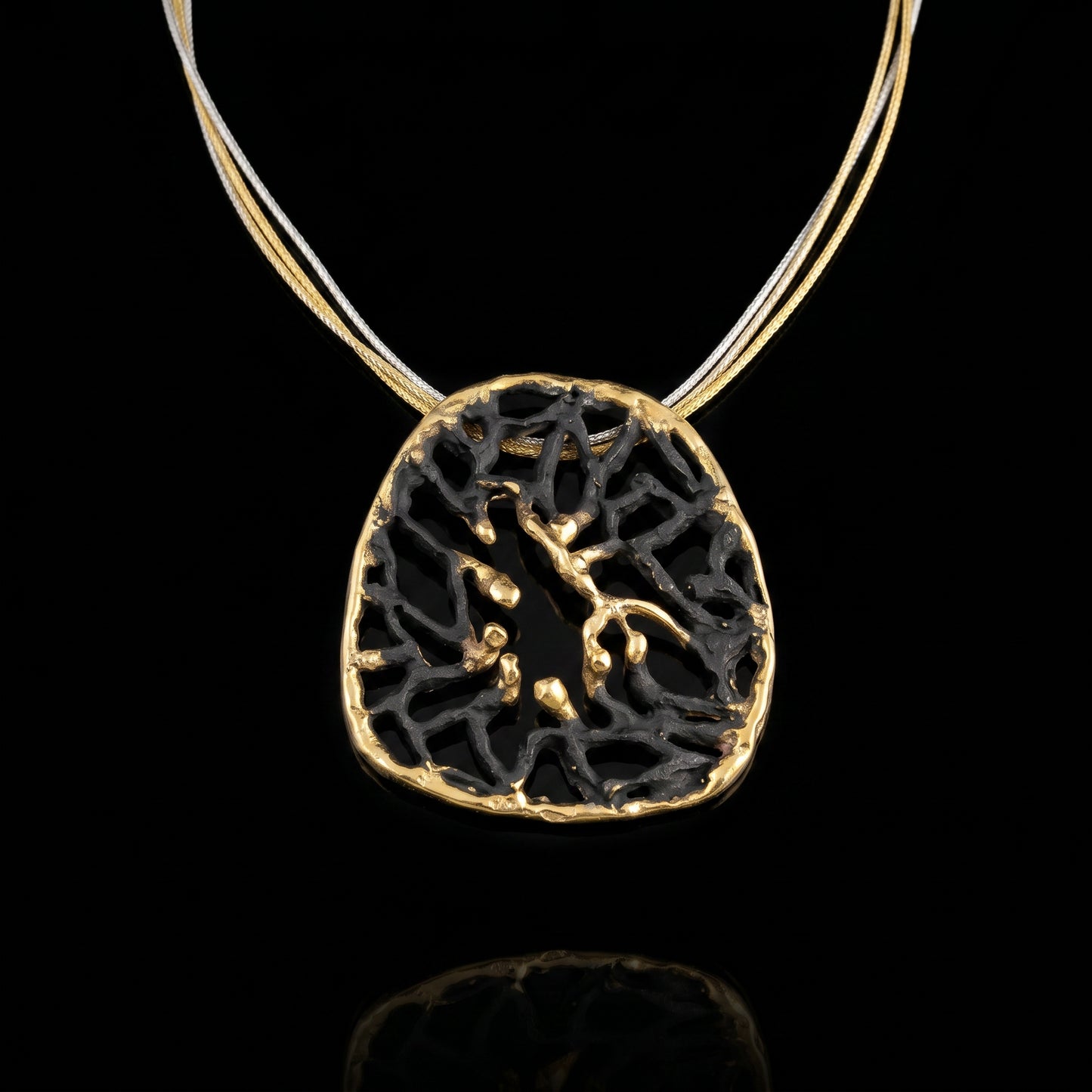 Orbis pendant with dark round filigree and gold-toned rim on thin chain