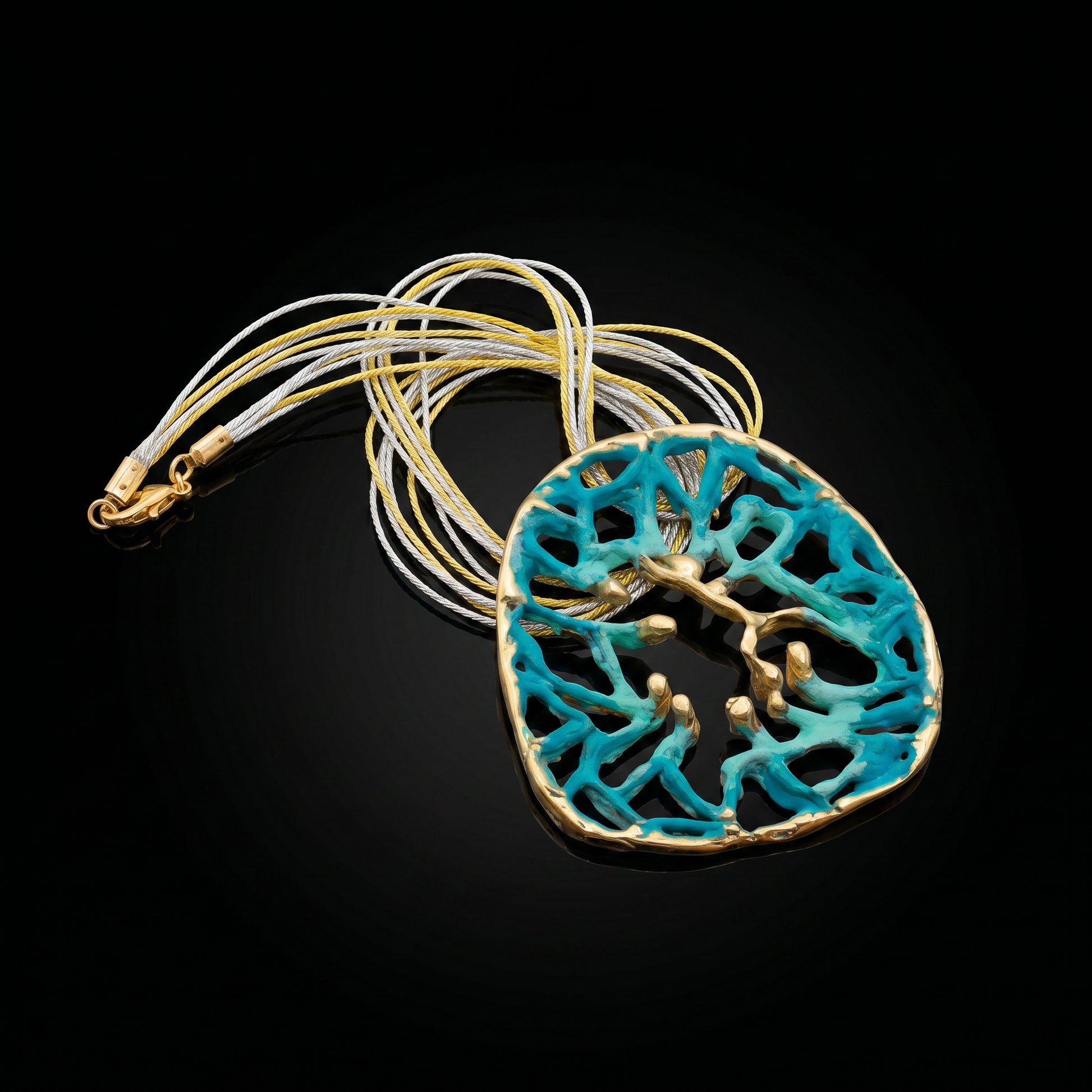 Orbis pendant with turquoise round filigree cutout and gold-toned rim on chain