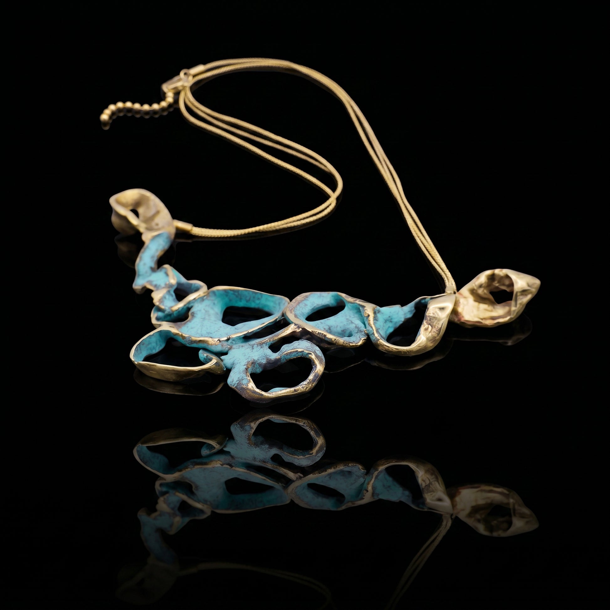 Turquoise coral-style pendant necklace with gold-tone chain and sculpted metal links