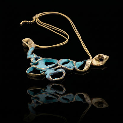 Turquoise coral-style pendant necklace with gold-tone chain and sculpted metal links