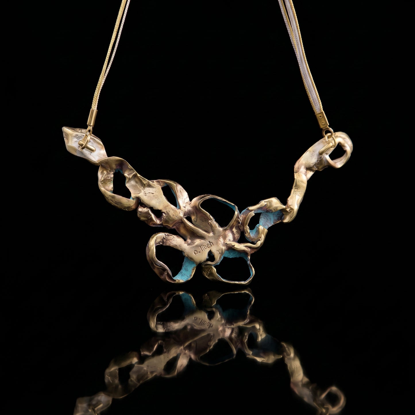 Turquoise coral pendant necklace with gold-tone chain and mixed metal charm links