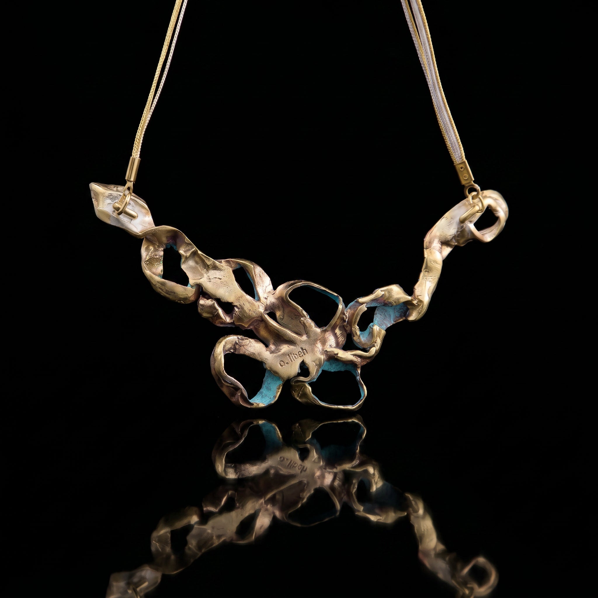 Turquoise coral pendant necklace with gold-tone chain and mixed metal charm links