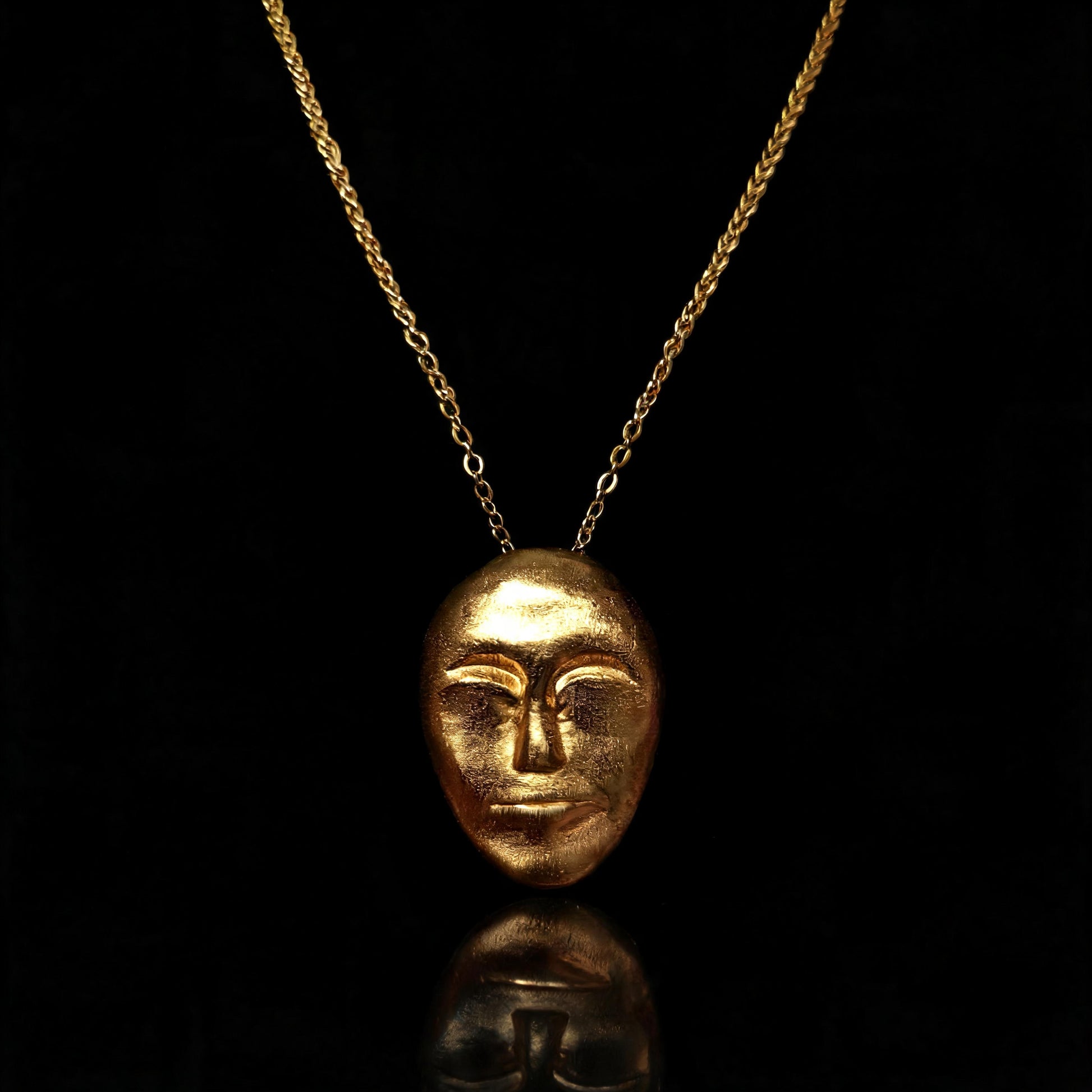 Gold face-mask pendant necklace with a fine chain link