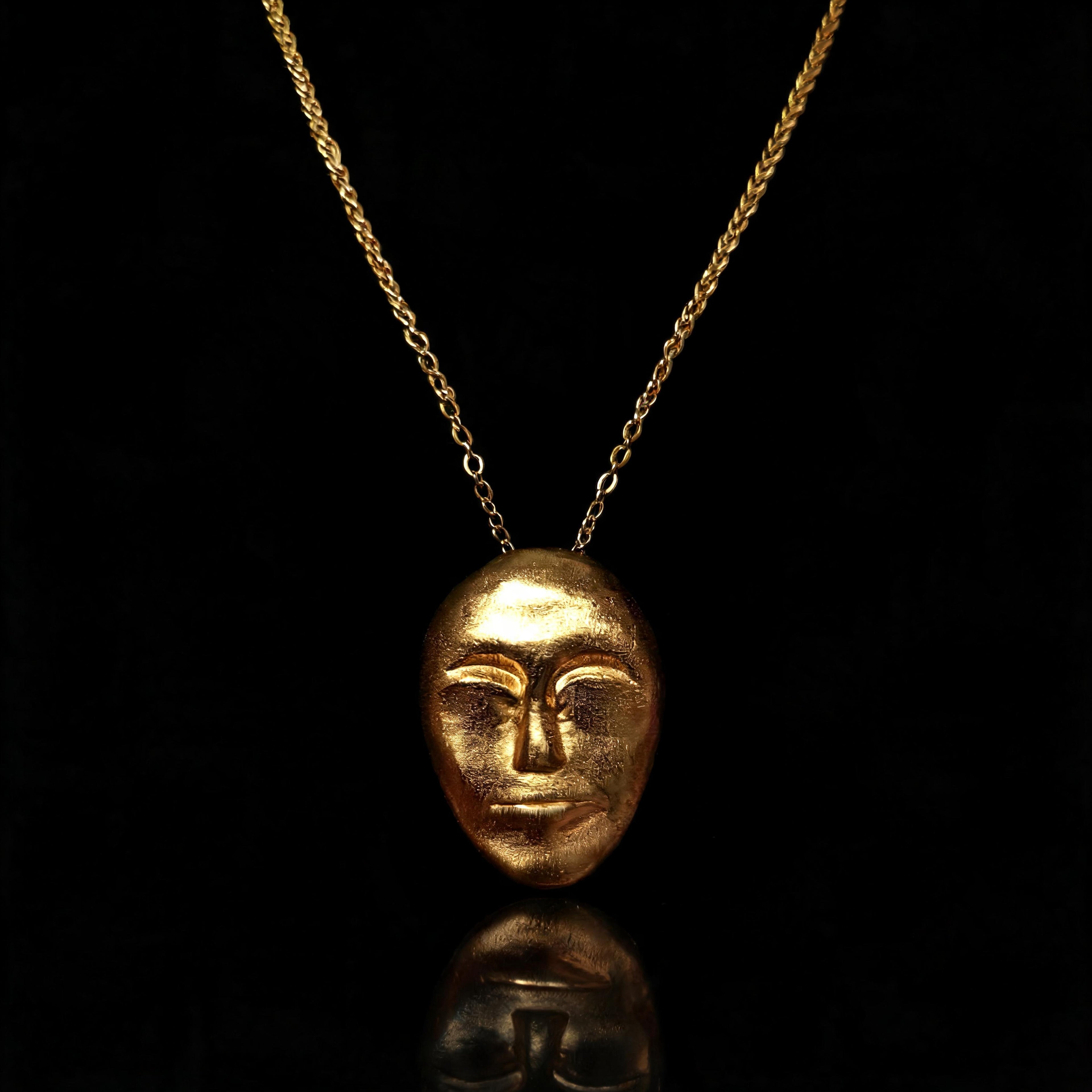 Gold face-mask pendant necklace with a fine chain link