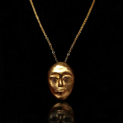 Gold face-mask pendant necklace with a fine chain link